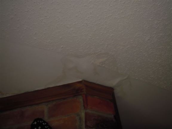 Here you can see a water-damaged ceiling near a chimney � most likely due to a flashing issue.
